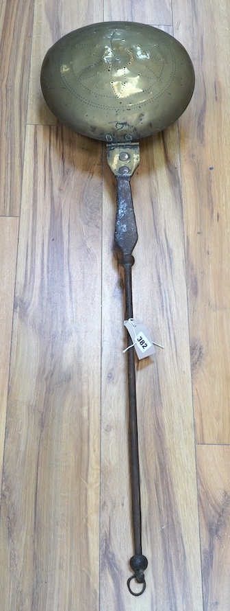 A 17th century brass and iron warming pan, 112cm. Condition - poor